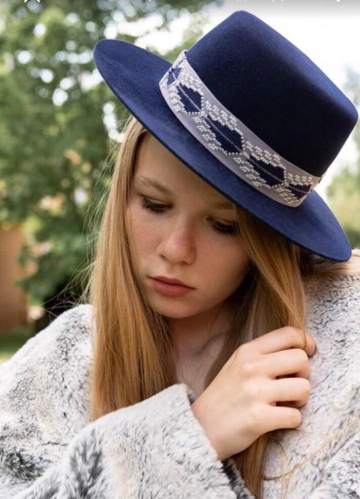 Classic brown and blue boater hat with flat brim and hand-embroidered ribbon, handcrafted in Geneva.