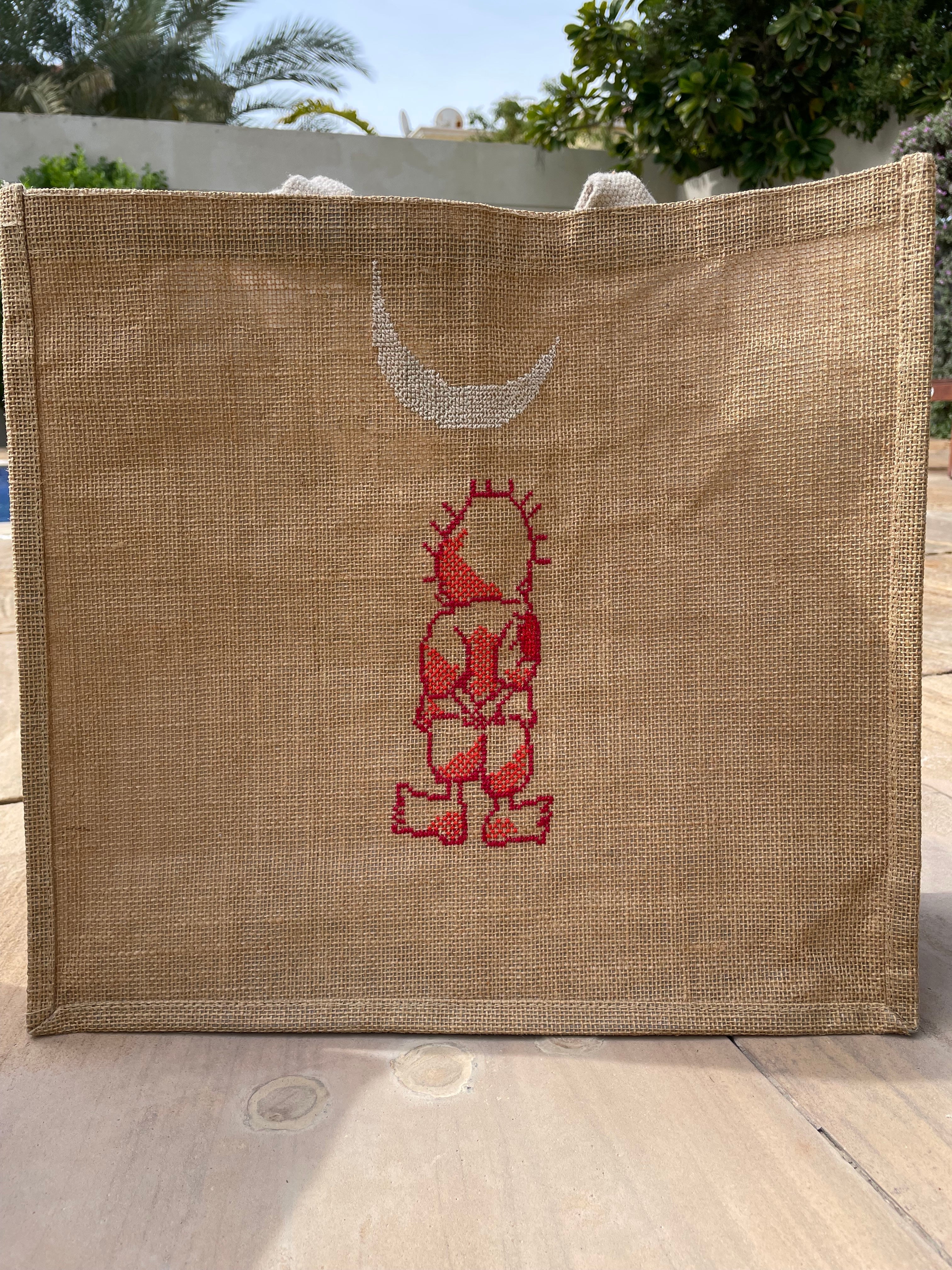 Jute tote bag with Handala hand-embroidery, showcasing its eco-friendly material and craftsmanship.