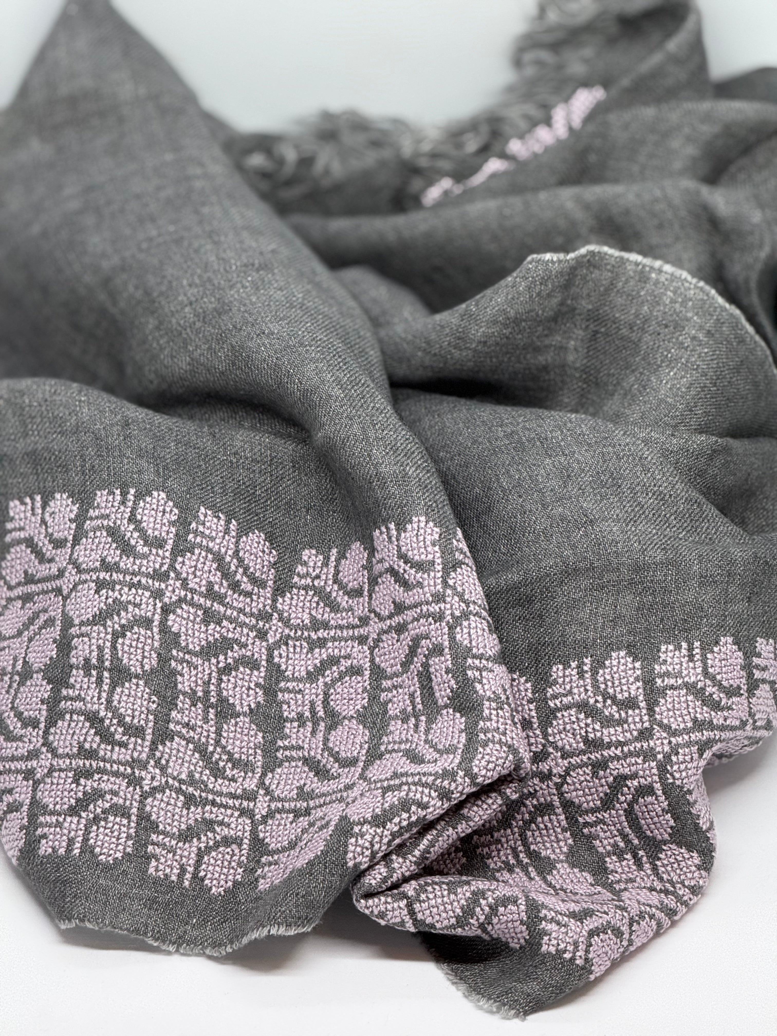 Gray scarf with intricate pattern on a white background