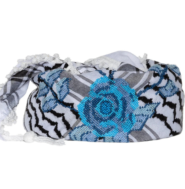 Decorative headband with blue rose and patterned design on a white background