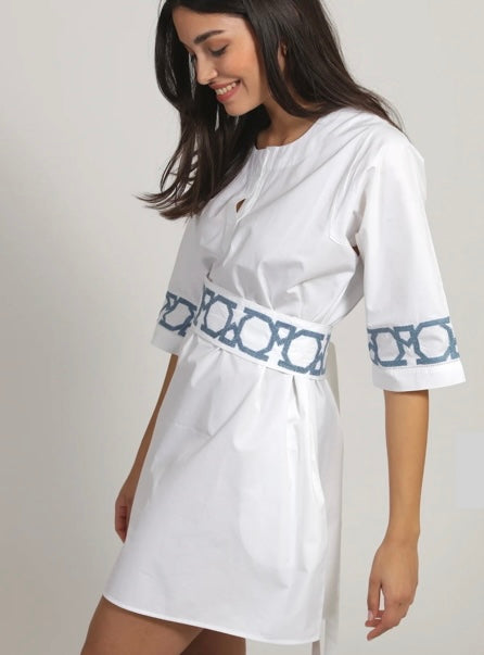 White linen dress, handcrafted by refugee artisans
