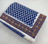 Folded fabric with blue and white pattern on a light gray background