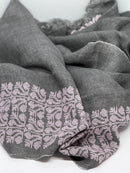 Gray scarf with intricate pattern on a white background
